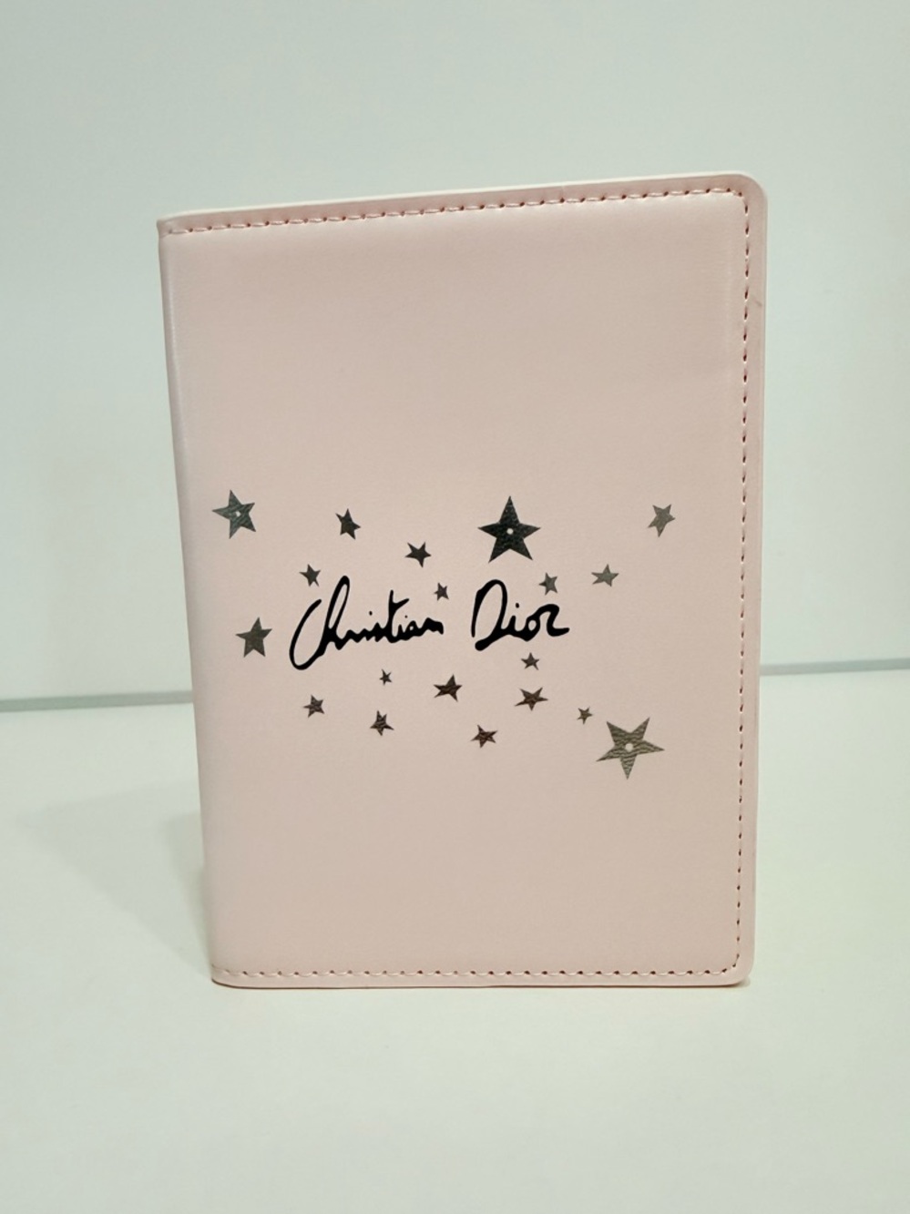 Dior Soft Pink Passport Cover with Dior Star logo on front